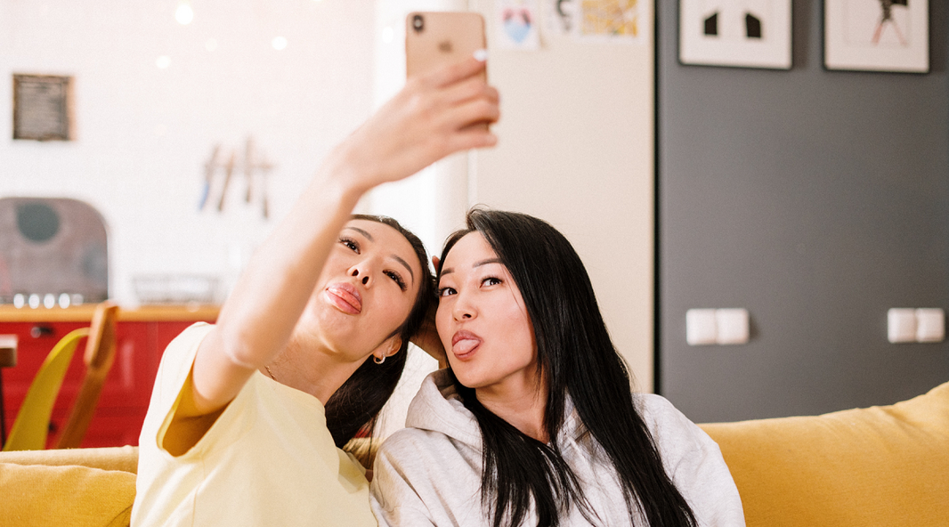 Friends taking selfies