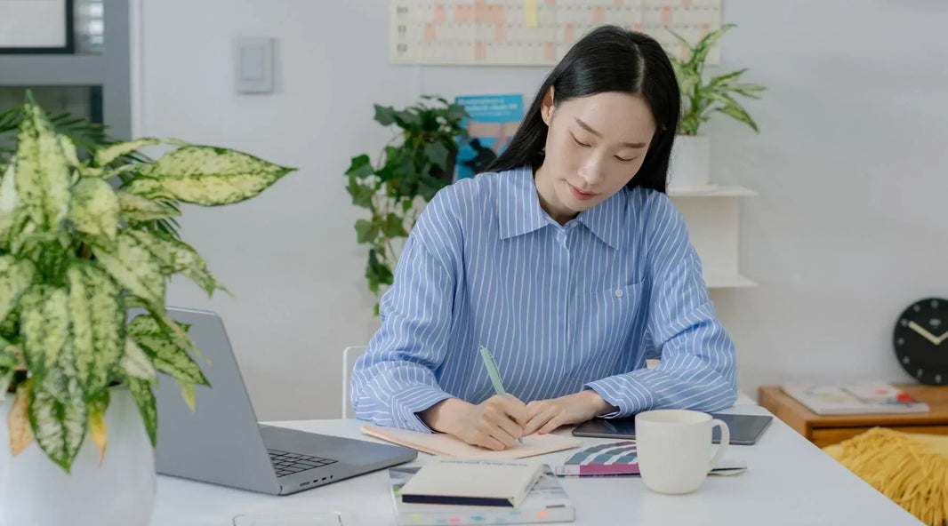 Woman writing on notebook journal