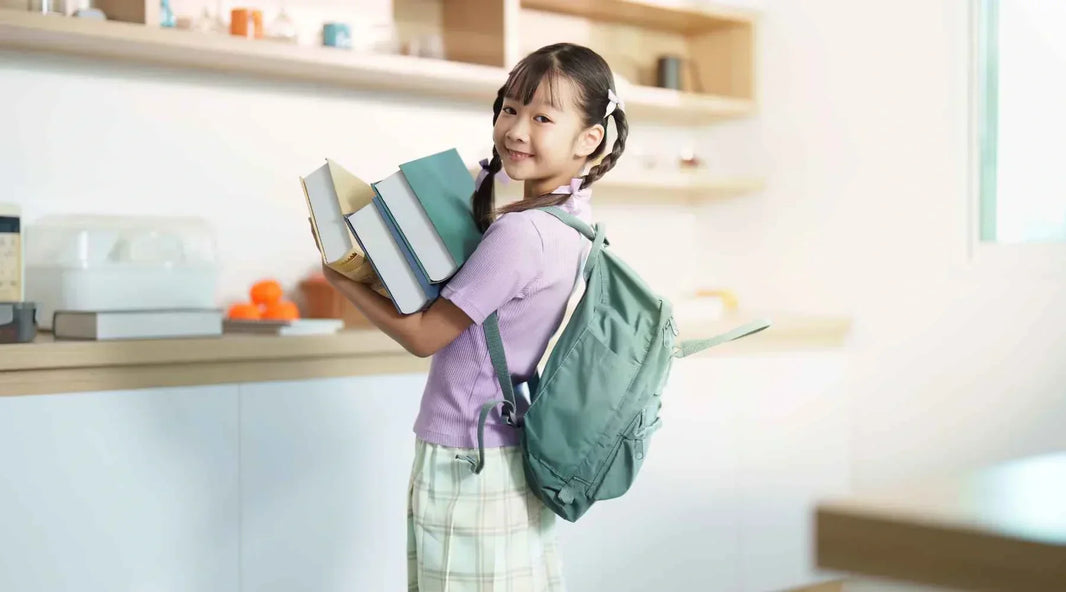 Girl with backpack carrying books